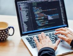 Student in California starting a computer engineering career with laptop, coding screen, and circuit board project.