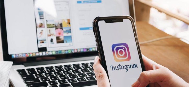 Content creator using Instagram analytics to grow followers organically on mobile phone