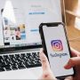 Content creator using Instagram analytics to grow followers organically on mobile phone